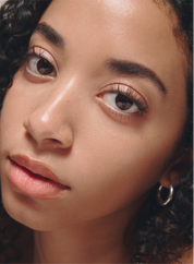 Close-up of a person with curly hair and clear skin